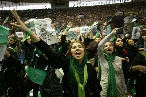 Supporters of Iranian former Prime mMinister and leading reformist candidate Mir-Hossein Mousavi cheer during a election campaign at the Azadi sport complex in Tehran Iran on May 23 2009. Iran\