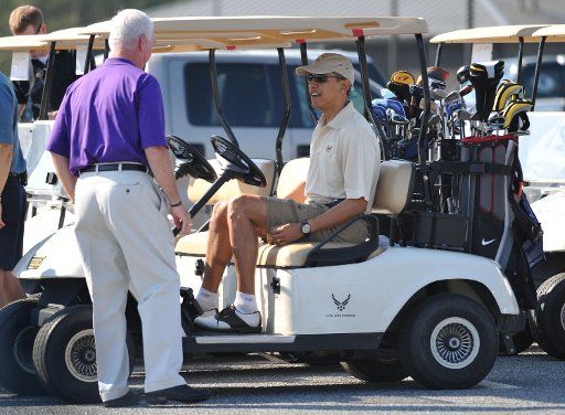 President Barack Obama talks to golf course general manager Mike Thomas prior to playing a round of golf at Andrews Air Force Base in Maryland on April 26 2009. (UPI Photo\/Kevin Dietsch)