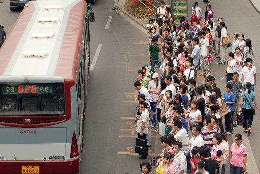 Large crowds of Chinese wait for public transportation at a bus stop in Beijing on June 22 2009. Despite the incredible growth in private car ownership in China over the last few years the vast majority of Chinese commuters still depend on cheap ...