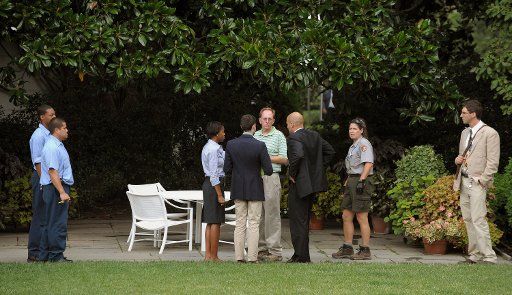 White House staffers stand in the Rose Garden of the White House where U.S. President Barack Obama is set to have a beer with Prof. Henry Louis Gates Jr. and Sgt. James Crowley later in the evening in Washington on July 30 2009. UPI Photo\/Roger L....