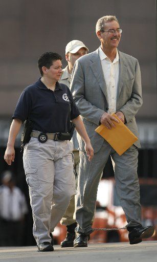 Financier R. Allen Stanford (R) is escorted into the federal courthouse in shackles for a hearing on whether an order granting him bail should be reversed in Houston Texas on June 29 2009. Stanford was indicted by a federal grand jury along with ...