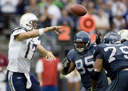 San Diego Chargers quarterback Phillips Rivers passes under pressure from Seattle Seahawks Red Bryant (79) and Kentwan Balmer (95) in the third quarter on Sunday September 26 2010 at Qwest Field in Seattle. The Seahawks beat the Chargers 27-20. ...