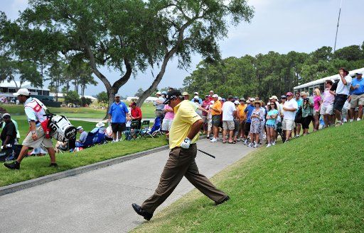 Angel Cabrera walks down a hillside and across a cart path after hitting a shot from way left of the 16th green during the third round of The Players Championship Saturday May 14 2011 on the Stadium Course at TPC Sawgrass in Ponte Vedra Beach ...