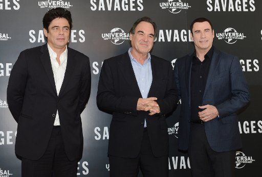 American actors Benicio Del Toro and John Travolta with director Oliver Stone attend a photo call for "Savages" at Mandarin Oriental Hotel in London on September 19, 2012. UPI\/Rune