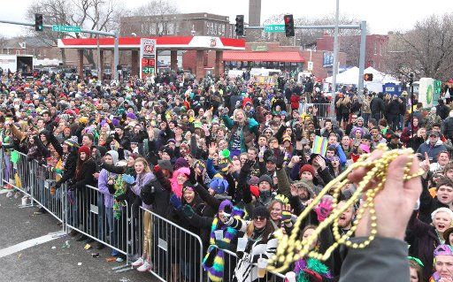 Thousands of parade goers yell for beads from those riding on floats during the annual Mardi Gras Parade in St. Louis on February 14, 2015. Photo by Bill Greenblatt\/