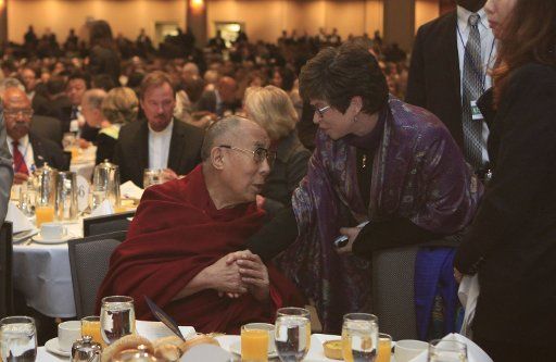 White House adviser Valerie Jarrett talks to the Dalai Lama as President Barack Obama attends the National Prayer Breakfast in Washington, DC on February 5, 2015. Obama discussed the power of religion for good around the world but also discussed ...