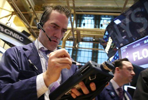 Traders works on the floor of the New York Stock Exchange at the opening bell on Wall Street in New York City on April 14, 2015. Photo by John Angelillo\/