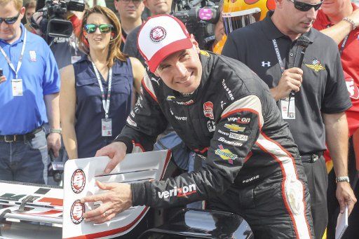 Will Power affixes the sticker to a wing of his car showing he won the pole during Grand Prix of Indianapolis qualifying at the Indianapolis Motor Speedway on May 9, 2015 in Indianapolis, In. Photo by Amy Frederick\/