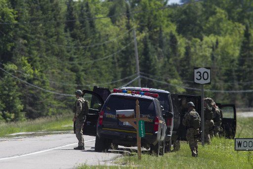 Law enforcement personnel search along Route 30 near the Elephant Head trail in Malone, New York after cornering two escaped prisoners on June 26, 2015. At least one prisoner, Richard Matt, is believed to have been shot dead by law enforcement and ...