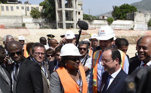 French President Francois Hollande(2nd-R) and Haitian president Michel Martelly (R), visit the site of the of the Haiti State University hospital, on May 12, 2015 in Port-au-Prince Haiti. Pool photo by Alain Jocard\/