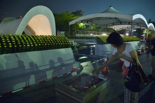 People pray for the atomic bomb victims at Hiroshima Peace Memorial Park on the 70th anniversary of the atomic bombing in Hiroshima, Japan, on August 5, 2015. Photo by Keizo Mori\/