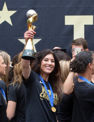 Goal keeper Hope Solo holds the trophy aloft as the United States of America women\