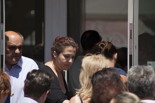 People line up at an ATM outside an Eurobank branch in Athens, Greece on July 8, 2015. Greece asked for more funds from the European Union as it prepared a last ditch effort on economic reforms to stay in the Euro before a fast-approaching deadline....