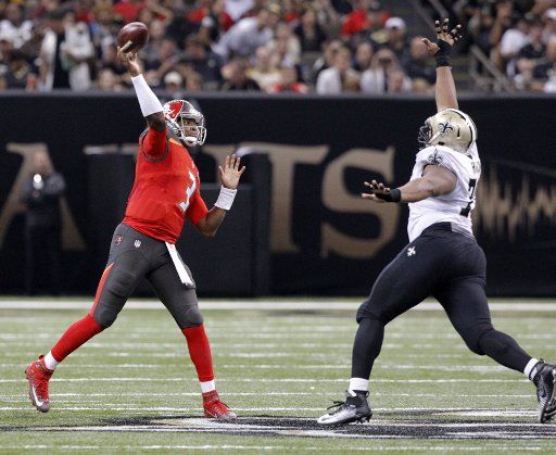 Tampa Bay Buccaneers quarterback Jameis Winston (3) throws down field as New Orleans Saints defensive end Bobby Richardson (78) applies pressure during the second quarter at the Mercedes-Benz Superdome in New Orleans September 20, 2015. Photo by AJ ...