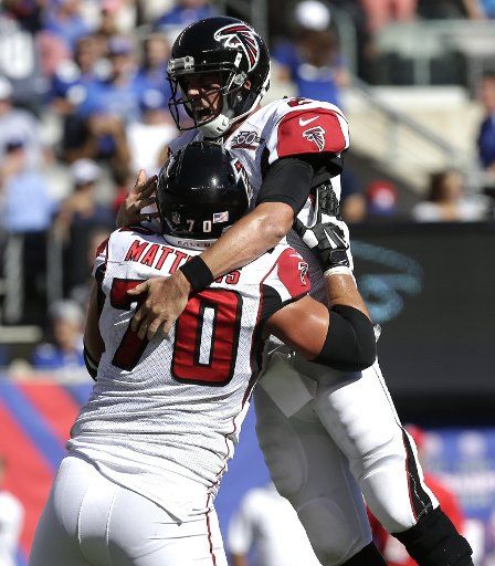 Atlanta Falcons quarterback Matt Ryan and Jake Matthews celebrate a touchdown in the 4th quarter against the New York Giants at MetLife Stadium in East Rutherford, New Jersey on September 20, 2015. The Falcons defeated the Giants 24-20. Photo by ...
