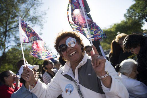 A woman celebrates along the parade route for Pope Francis, following a State Arrival ceremony at the White House in Washington, D.C. on September 23, 2015. Photo by Kevin Dietsch\/