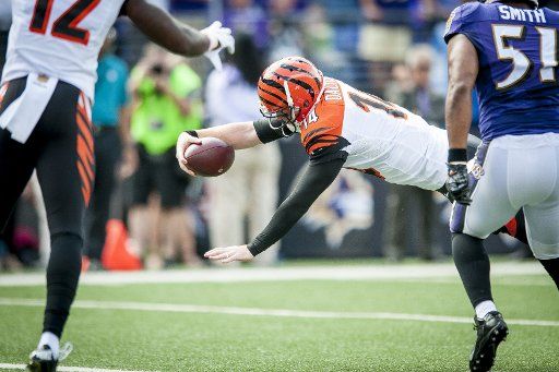 Cincinatti Bengal quarterback, Andy Dalton, dives for a touchdown during the first quarter against the Baltimore Ravens at M&M Bank Stadium on September 27, 2015 in Baltimore, Maryland. Photo by Pete Marovich\/