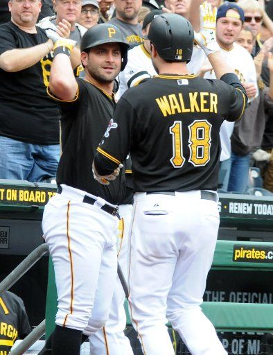 Pittsburgh Pirates second baseman Neil Walker (18) celebrates his solo homer with Pirates Francisco Cervelli (L) in the second inning against the St. Louis Cardinals at PNC Park in Pittsburgh on September 30, 2015. Photo by Archie Carpenter\/