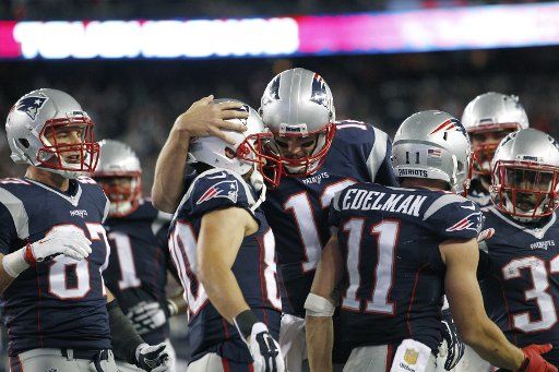 New England Patriots quarterback Tom Brady (12) gives a hug to wide receiver Danny Amendola (80) after the Patriots scored on a 16-yard touchdown reception by wide receiver Julian Edelman in the fourth against the Miami Dolphins at Gillette Stadium ...
