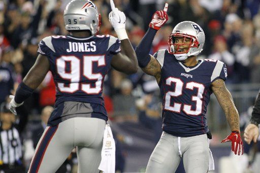New England Patriots defensive end Chandler Jones (95) celebrates with safety Patrick Chung (23) after Jones sacked Miami Dolphins quarterback Ryan Tannehill (17) in the second quarter at Gillette Stadium in Foxborough, Massachusetts on October 29, ...