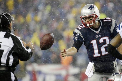 New England Patriots quarterback Tom Brady tosses a football to an official on the field in the second half against the Indianapolis Colts in the AFC Championship Game at Gillette Stadium in Foxborough, Massachusetts on January 18, 2015. The NFL is ...