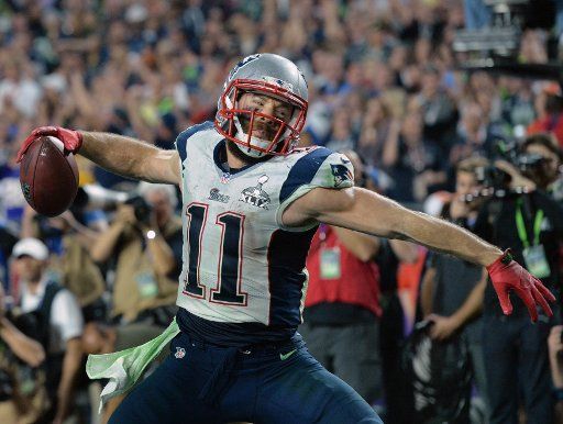 New England Patriots Julian Edelman celebrates after catching a Tom Brady pass for a three yard TD against the Seattle Seahawks in the fourth quarter of Super Bowl XLIX at University of Phoenix Stadium in Glendale, Arizona, February 1, 2015. Photo ...