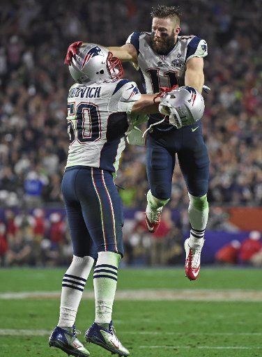 New England Patriots Rob Ninkovich (50) and WR Julian Edelman (R) celebrate a Malcolm Butler interception of a Seattle Seahawks pass with 26 seconds remaining in Super Bowl XLIX at University of Phoenix Stadium in Glendale, Arizona, February 1, 2015....