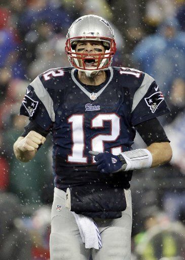 New England Patriots quarterback Tom Brady celebrates in the rain after LeGarrett Blount runs for a 13 yard touchdown in the third quarter against the Indianapolis Colts in the AFC Championship Game at Gillette Stadium in Foxborough, Massachusetts ...