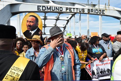 Spyra Gordon, one of the original marchers, wipes his eyes after ceremoniously crossing the historic Edmund Pettus Bridge with thousands of others to remember the violent clash between civil rights activists and police during the March on Selma 50 ...