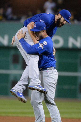 Chicago Cubs Jake Arrieta is lifted in the air by 1B Anthony Rizzo after defeating the Pittsburgh Pirates in the National League Wild Card at PNC Park in Pittsburgh on October 7, 2015. Arrieta pitched a four hit shutout to defeat the Pirates 4-0 to ...