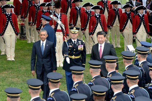 U.S. President Barack Obama and Chinese President Xi Jinping review the troops during the official welcoming ceremony for the Chinese leader on the South Lawn of the White House in Washington, DC on September 25, 2015. Xi and Obama later met in the ...