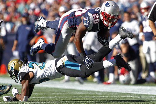 New England Patriots running back James White (28) is upended by Jacksonville Jaguars cornerback Demetrius McCray (35) nine-yard reception in the fourth quarter at Gillette Stadium in Foxborough, Massachusetts on September 27, 2015. The Patriots ...