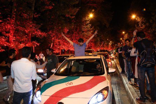 Iranians celebrate on the streets of Tehran after the announcement of Iran\