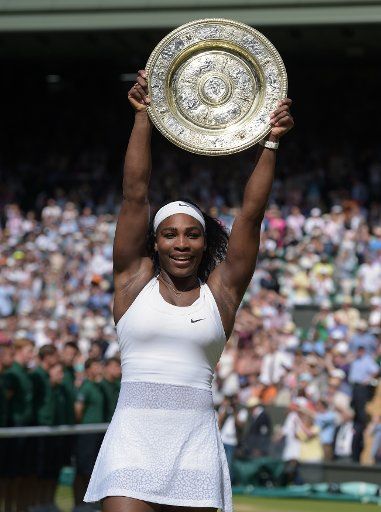 American Serena Williams holds the trophy after winning the Women\