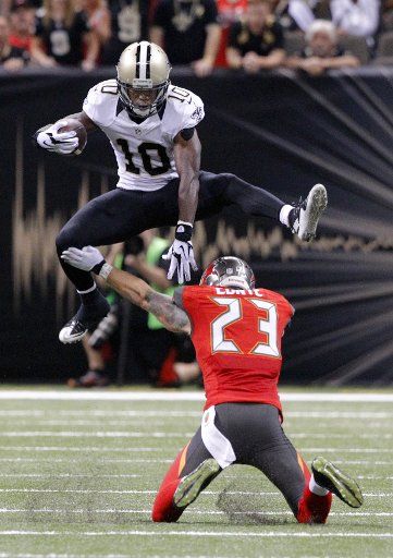 New Orleans Saints wide receiver Brandin Cooks (10) gains 21-yards before being tripped up by Tampa Bay Buccaneers defensive back Chris Conte (23) during the fourth quarter at the Mercedes-Benz Superdome in New Orleans, September 20, 2015. Photo by ...