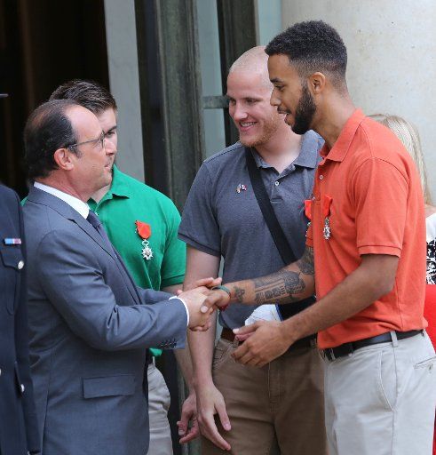 (From L to R) French President Francois Hollande, Alek Skarlatos, Spencer Stone and Anthony Sadler leave the Elysee Palace in Paris on August 24, 2015. Skarlatos, Stone and Sadler received the French Legion of Honor - France\