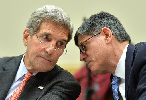 Secretary of State John Kerry (L) and Treasury Secretary Jack Lew talk as they testify during a House Foreign Affairs Committee hearing on the Obama administration\