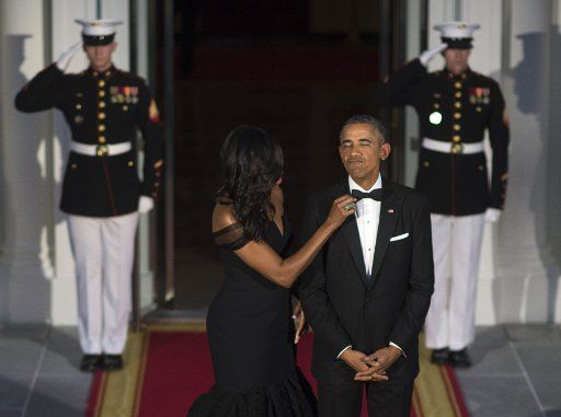 First Lady Michelle Obama adjusts President Barack Obama\