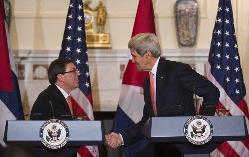 U.S. Secretary of State John Kerry (R) shakes hands with Cuban Foreign Minister Bruno Rodriguez Parrilla following a joint press conference at the State Department in Washington, D.C. on July 20, 2015. Kerry announced the U.S. will start to ...