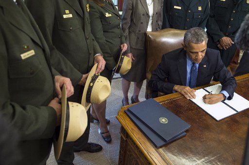 President Barack Obama signs legislation as he designates three new national monuments of Berryessa Snow Mountain in California; Waco Mammoth in Texas; and the Basin and Range in Nevada, in the Oval Office at the White House in Washington, D.C. on ...