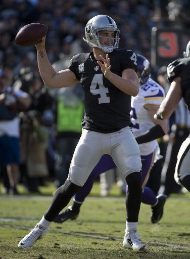 Oakland Raiders QB Derek Carr (4) drops back to pass in the first quarter against the Minnesota Vikings at O.co Coliseum in Oakland, California on November 15, 2015. Photo by Terry Schmitt\/