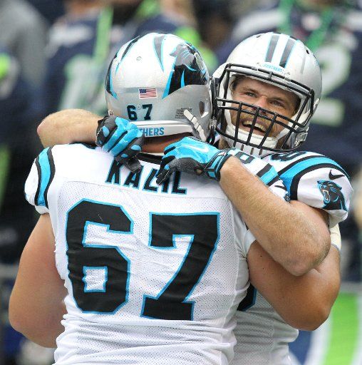 Carolina Panthers tight end Greg Olsen hugs his lineman center Ryan Kalil (67) after catching the winning touchdown against the Seattle Seahawks at CenturyLink Field in Seattle on October 18, 2015. The Panthers came from behind with 32 seconds ...