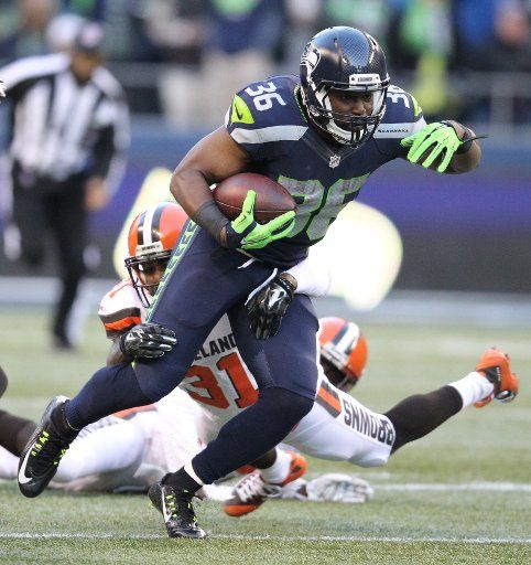 Seattle Seahawks running back Bryce Brown breaks a tackle by Cleveland Browns defensive back Donte Whitner (31) at CenturyLink Field in Seattle, Washington on November 29, 2015. The Seahawks clinched their fourth straight playoff berth in four ...