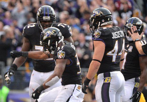 Baltimore Ravens Javorius Allen celebrates after rushing for a 3-yard touchdown against the Pittsburgh Steelers in the third quarter at M&T Bank Stadium in Baltimore, Maryland on December 27, 2015. The Ravens defeated the Steelers 20-17. Photo by ...