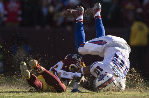 Buffalo Bills wide receiver Robert Woods (10) is stopped by Washington Redskins cornerback Deshazor Everett (22) during the first quarter at FedEx Field in Landover, Maryland on December 20, 2015. Photo by Kevin Dietsch\/