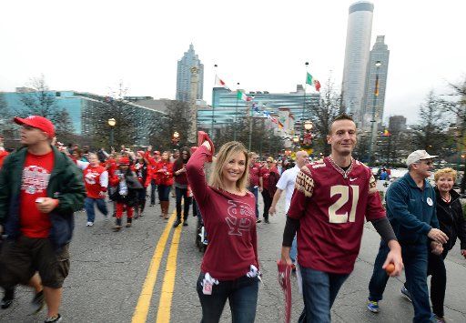 Marching bands, floats and dignitaries make their way down Andrew Young International Boulevard for the annual Chick-fil-A Peach Bowl Parade where Florida State University faced the University of Houston December 31, 2015, in Atlanta. Photo by David ...