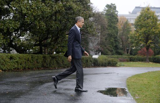 President Barack Obama walks across the South Lawn before departing the White House on board Marine One November 29, 2015 in Washington, DC. Nearly 150 world leaders including President Obama are expected to descend on Paris for the start of the ...