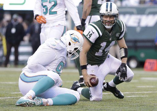 New York Jets Ryan Fitzpatrick smiles after a 10 yard run in the 3rd quarter against the Miami Dolphins at MetLife Stadium in East Rutherford, New Jersey on November 29, 2015. The Jets defeated the Dolphins 38-20. Photo by John Angelillo\/