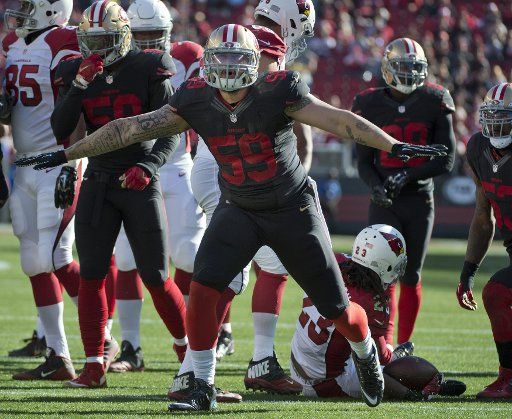 San Francisco 49ers Aaron Lynch (59) celebrates stopping Arizona Cardinals Chris Johnson (23) in the first quarter at Levi\