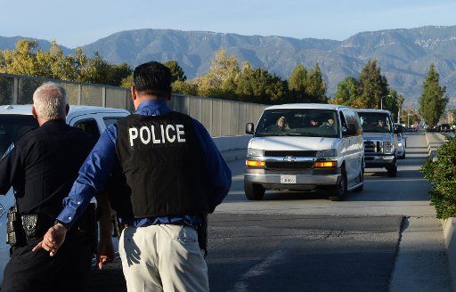 Police block streets as they search for three gunman who killed at least 14 people in San Bernardino, California on December 2, 2015. The gunmen wearing military-style gear open fire at the Inland Regional Center, a social services center that ...
